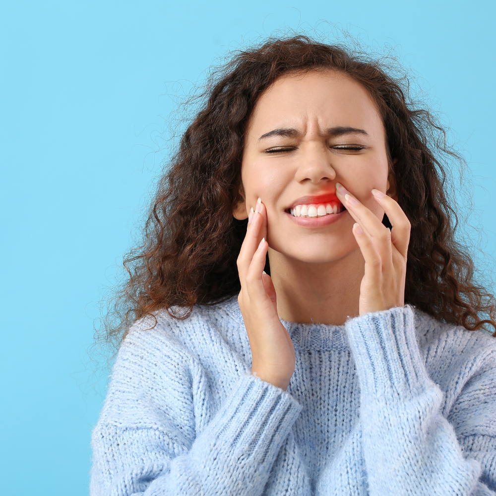 woman aching from gum pain.